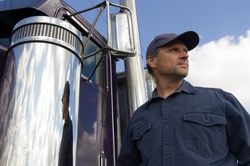 Image of long haul truck driver and his truck