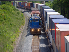 Image of two cargo freight trains passing one another on tracks